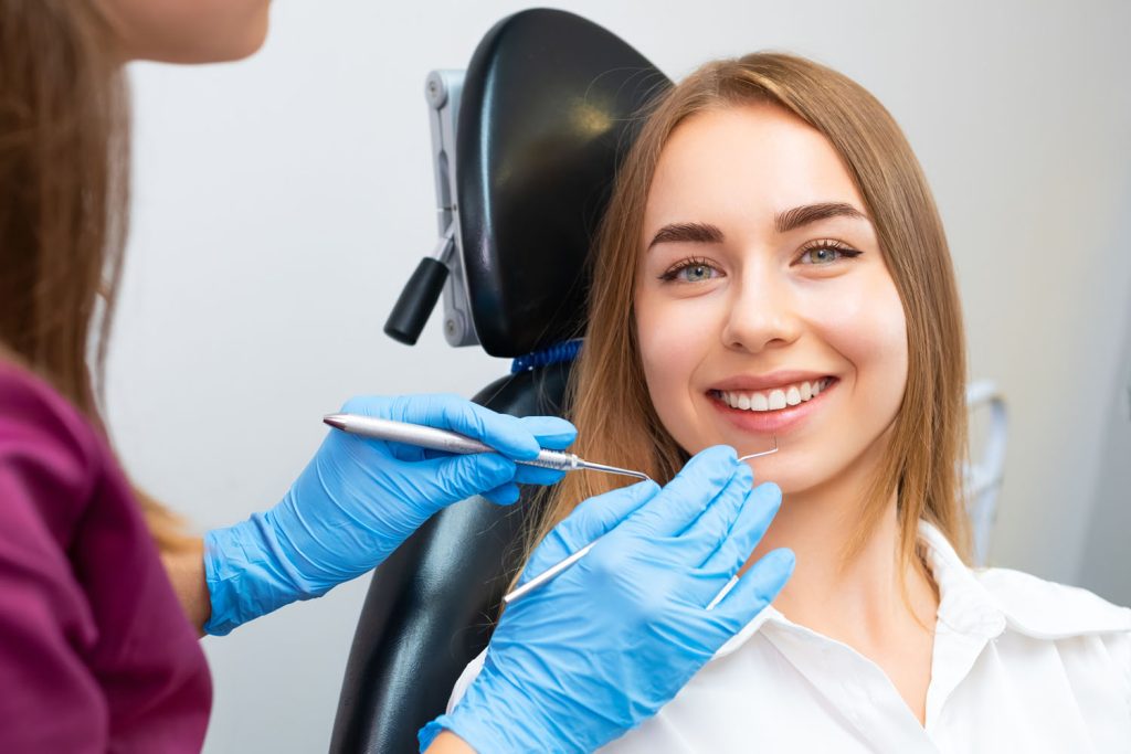 portrait of smiling woman sitting in dental chair 2026 03 20 00 22 26 utc
