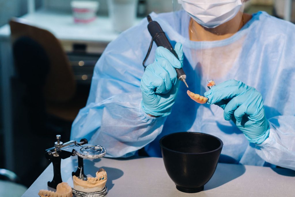 a dental technician in protective clothing is work 2026 03 24 15 23 04 utc