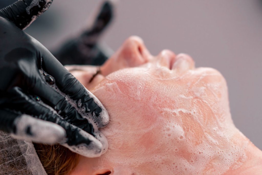 close up beautician in gloves rubs the foam with m 2026 03 15 23 21 46 utc
