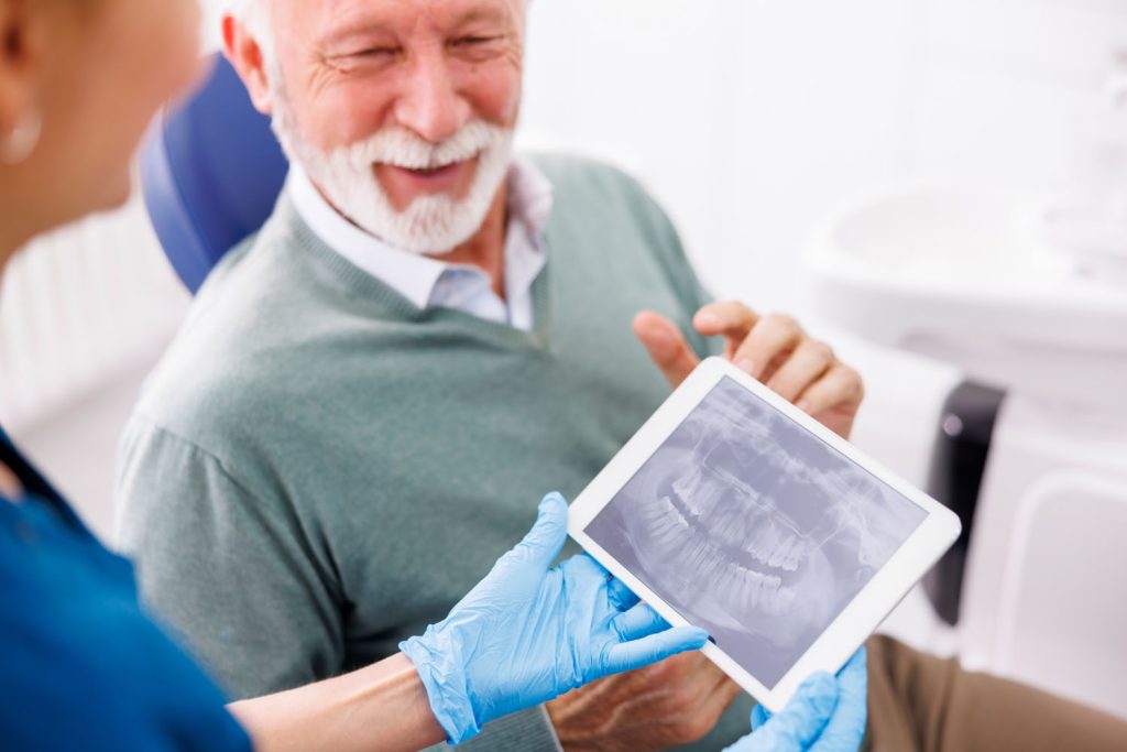 doctor and patient looking at jaw x ray at dental 2026 03 20 04 37 16 utc