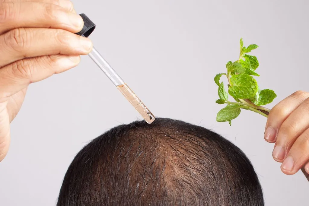 bald man using peppermint essential hair oil in a 2026 03 18 05 43 19 utc