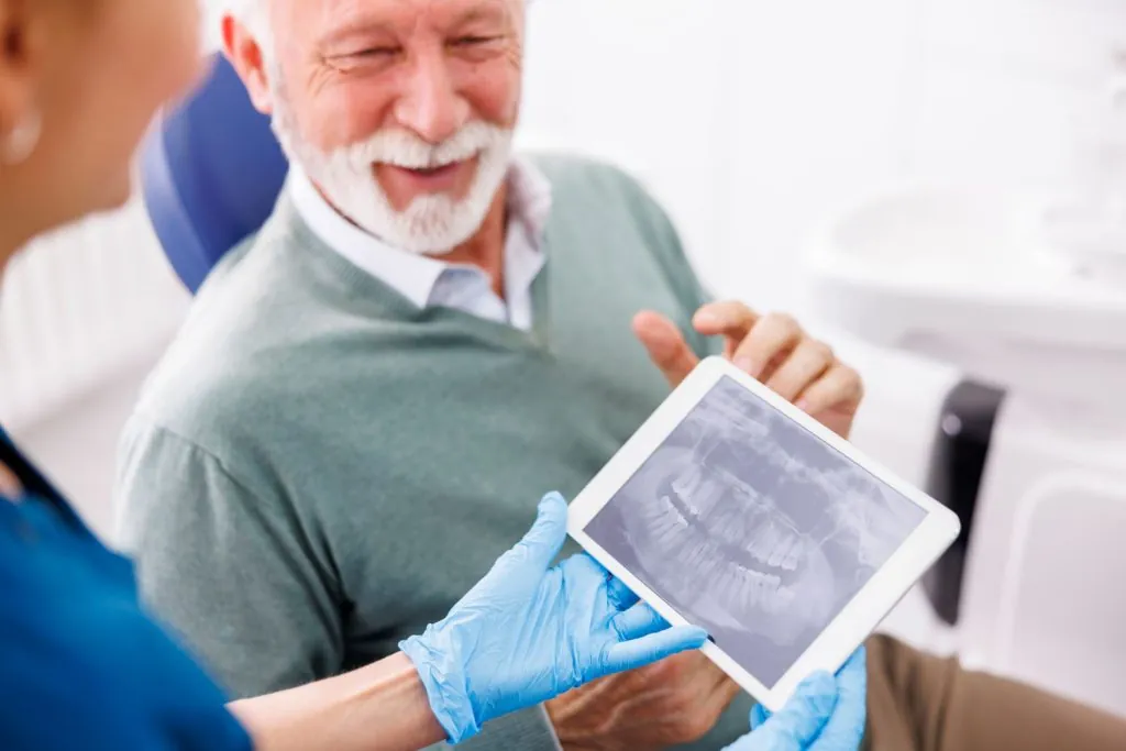 doctor and patient looking at jaw x ray at dental 2026 03 20 04 37 16 utc