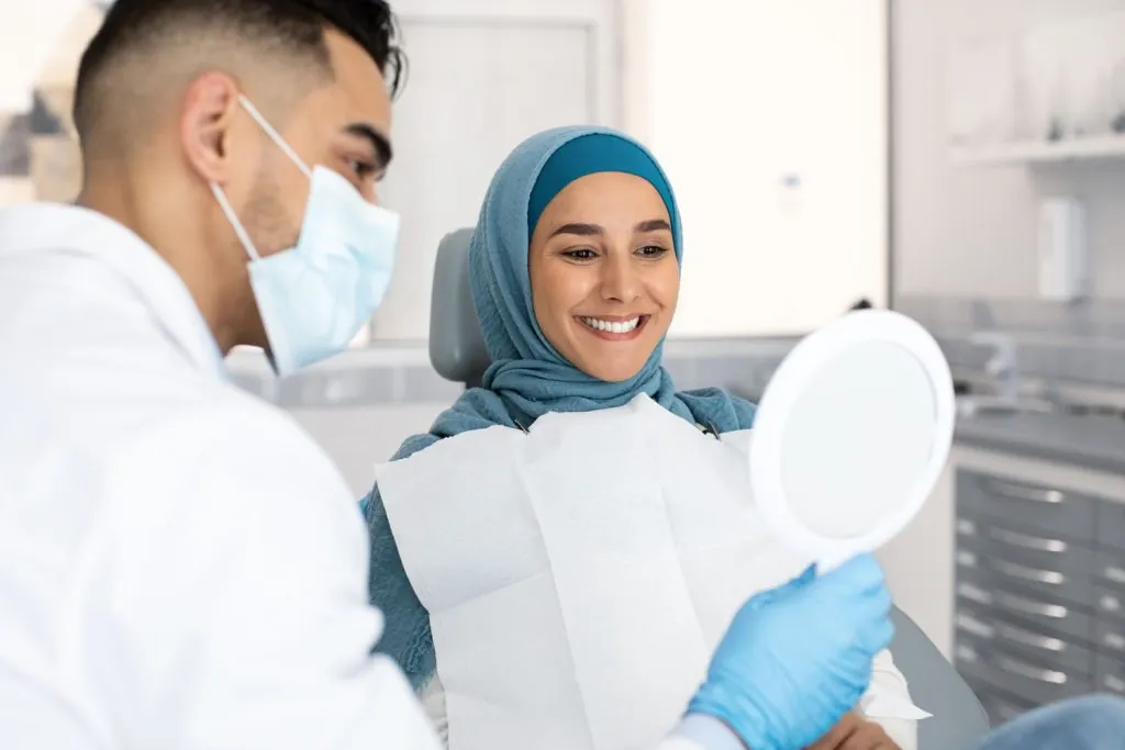 muslim lady in hijab looking at her new smile afte 2026 03 25 08 37 19 utc